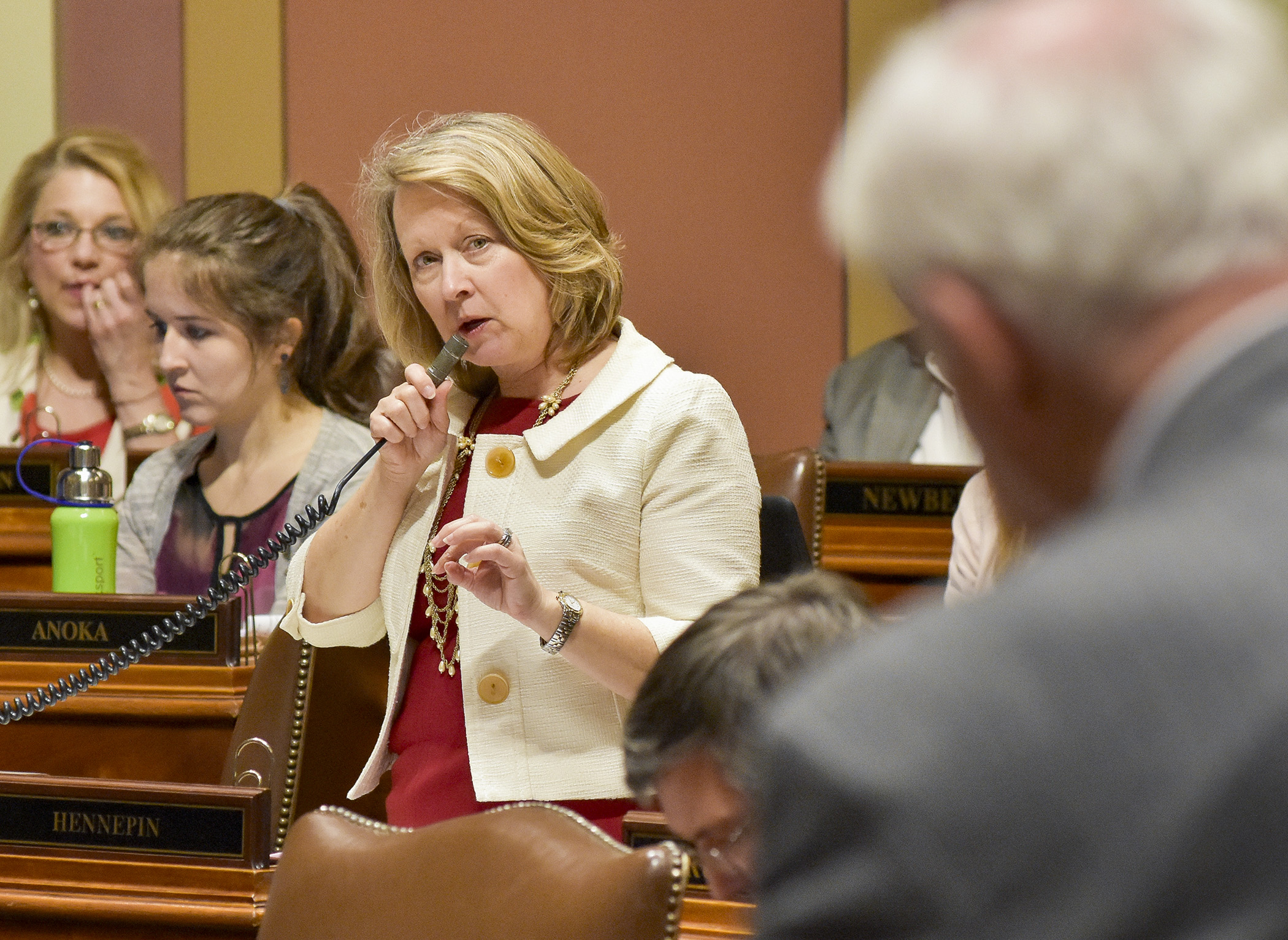 Jenifer Loon, chair of the House Education Finance Committee, responds to a question from Rep. Lyndon Carlson, Sr., foreground, during April 25 floor debate of the omnibus education bill. Photo by Andrew VonBank